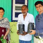 Pooja Bohra and Ajit Arun Waman distributing the blood fruit seedlings to a farmer